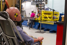 Researchers at the U-M Transporation Research Institute conduct tests to develop vehicle safety harnesses for wheelchairs.