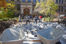 Landscape architecture students in the School of Natural Resources and Environment move concrete as they work on a class project to design and build a landscaping feature on the east side of Dana Hall.