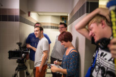 A group of students film a movie in a basement bathroom at Michigan Union.