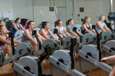 Members of the women's rowing team work out in the team room at the IM Sports Building.