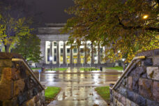 Angell Hall shines brightly as an early morning rain storm blows through central campus.
