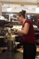 A barista preps a coffee order during the morning student rush at the Espresso Royal Cafe.