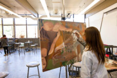 A student paints in a quiet studio at the Art and Architecture Building on North Campus.