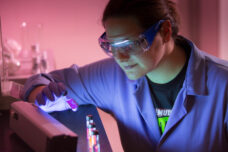A student in a Chemistry Department lab focuses on a series of nanoscale imaging agents developed for use in drug and gene delivery.